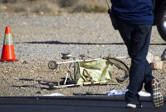 A stroller is shown in the area where a man and a baby were hit by a car on South Rainbow Boulevard near Warm Springs Road Monday, Nov. 24, 2014.