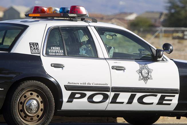 A Metro Police car is shown at an accident scene after a man and a baby were hit by a car on South Rainbow Boulevard near Warm Springs Road Monday, Nov. 24, 2014. 