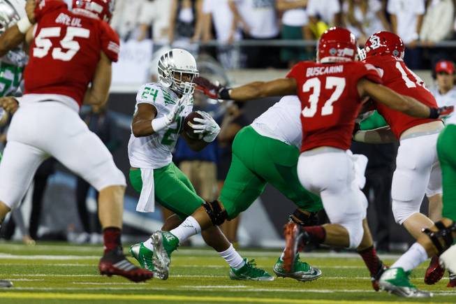 Oregon running back Thomas Tyner (24) runs the football against South Dakota during the second quarter of an NCAA college football game in Eugene, Ore., Saturday, Aug. 30, 2014 (AP Photo/Ryan Kang)