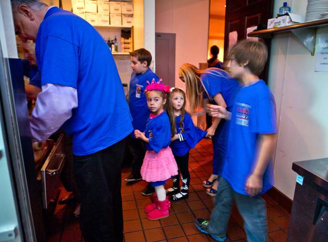 Even kids volunteer to help serve a complimentary Thanksgiving dinner at Piero's Italian Cuisine during the 24th annual Turkey Gobble for underprivileged children and families from local nonprofit organizations on Thursday, Nov. 27, 2014.