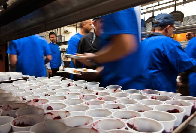 Cups of cranberry sauce await being plated in the kitchen at Piero's Italian Cuisine during the 24th annual Turkey Gobble on Thursday, Nov. 27, 2014. A complimentary Thanksgiving dinner is prepared for underprivileged children and families from local nonprofit organizations.