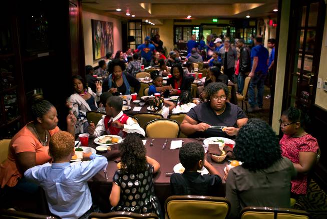 Families and friends enjoy a complimentary Thanksgiving dinner being served at the 24th annual Turkey Gobble at Piero's Italian Cuisine for underprivileged children and families from local nonprofit organizations on Thursday, Nov. 27, 2014.