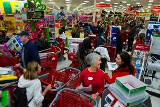 Employees and shoppers at Target in Henderson comb the store for Black Thursday on Thursday, November 27, 2014.