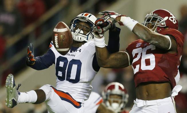 Alabama defensive back Landon Collins, right, breaks up a pass meant for Auburn wide receiver Marcus Davis during the first half of the Iron Bowl NCAA college football game, Saturday, Nov. 29, 2014, in Tuscaloosa, Ala.