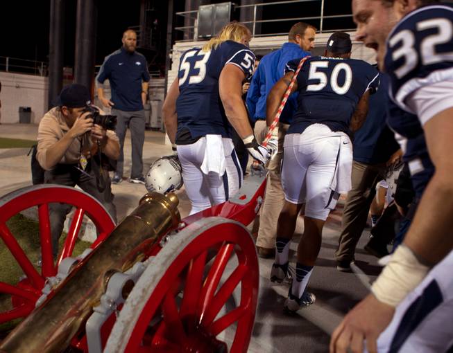 UNR players haul the Fremont Cannon into their locker room following their win over UNLV 49-27 at Sam Boyd Stadium on Friday, November 29, 2014.