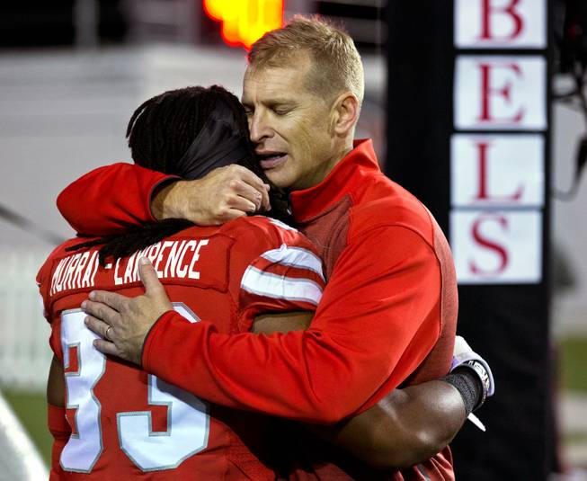 UNLV head coach Bobby Hauck hugs player Shaquille Murray-Lawrence (33) during each of their last games at Sam Boyd Stadium on Friday, November 29, 2014.