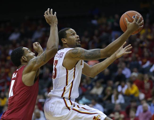 Iowa State guard Bryce Dejean-Jones (13) drives to the goal past Alabama forward Shannon Hale (11) in the first half of the CBE Hall of Fame Classic college baseball game Monday, Nov. 24, 2014, in Kansas City, Mo.