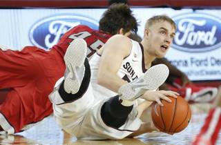 Arizona State's Jonathan Gilling, right, gains control of the ball after battling UNLV's Cody Doolin, left, during the second half of an NCAA college basketball game Wednesday, Dec. 3, 2014, in Tempe, Ariz. Arizona State defeated UNLV 77-55. (AP Photo/Ross D. Franklin)