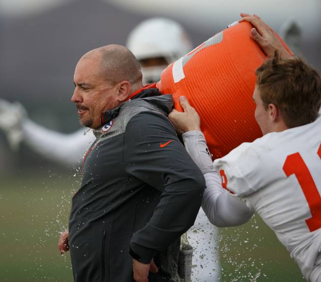 Bishop Gorman quarterback Tate Martell (18) gives Coach Tony Sanchez a Gatorade bath after the NIAA State Championship Football game between the Bishop Gorman Gaels and the Reed Raiders at Damonte Ranch High School in Reno, Nevada.