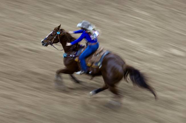 Barrel racer Samantha Lyne from Cotulla, Texas heads to her next barrel during the 56th Wrangler  National Finals Rodeo at the Thomas & Mack Center on Tuesday, December 9, 2014. L.E. Baskow.