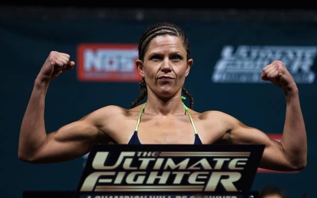 Strawweight fighter Emily Peters Kagan flexes while weighing in for the Ultimate Fighter reality show finale live from the Pearl at the Palms Casino on Thursday, December 11, 2014.