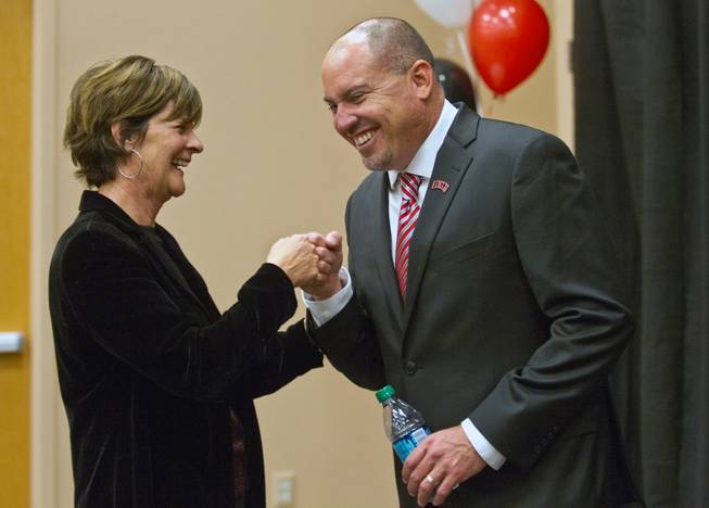 Tony Sanchez fist bumps with UNLV athletic director Tina Kunzer-Murphy after he is announced as the new UNLV football team head coach in the Stan Fulton Building ballroom on Thursday, December 11, 2014.