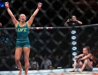 Carla Esparza celebrates her win over a dejected Rose Namajunas ending their Women's Strawweight title bout at the Pearl in the Palms on Friday, December 12, 2014.