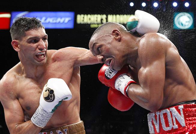 Amir Khan, left, of Britain battles with Devon Alexander of St. Louis, Mo. during a welterweight fight at the MGM Grand Garden Arena Saturday, Dec. 13, 2014.