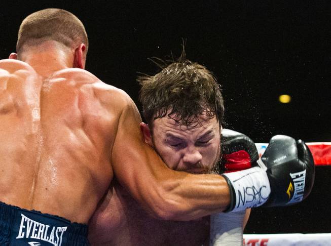 Andy Lee takes an arm to the face during a fight against Matt Korobov for the vacant WBO middleweight title at the Cosmopolitan on Saturday, December 13, 2014.
