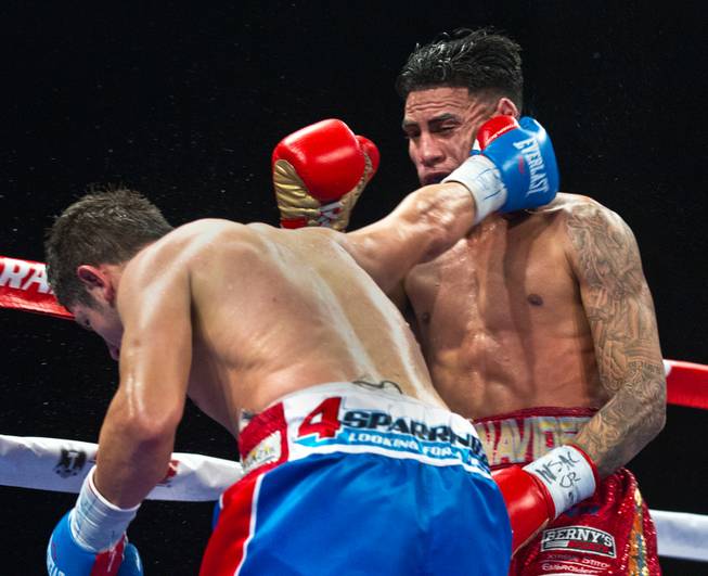 Mauricio Herrera connects to the side of the face of Jose Benavidez Jr. during their interim WBA super lightweight title fight at the Cosmopolitan on Saturday, Dec. 13, 2014.