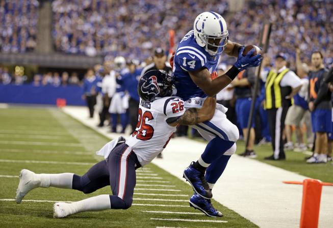 Indianapolis Colts wide receiver Hakeem Nicks, right, is tackled by Houston Texans defensive back Darryl Morris after a catch during the first half of an NFL football game in Indianapolis, Sunday, Dec. 14, 2014.