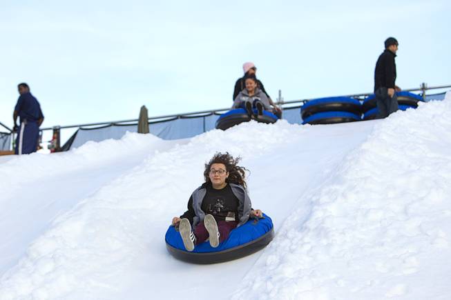 Aracely Martinez of Las Vegas heads down the Winter PARQ tubing hill in the Linq parking lot Sunday, Dec. 14, 2014. The Winter PARQ hill is open Monday through Friday from 4 p.m. to 10 p.m. and Saturday through Sunday from 2 p.m. to 10 p.m. The hill will close at 8:30 p.m. on Christmas Eve.