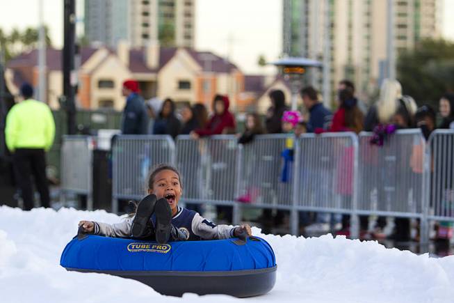 Kalia Wyatt, 8, screams as she rides a tube at the Winter PARQ tubing hill in the Linq parking lot Sunday, Dec. 14, 2014. The Winter PARQ hill is open Monday through Friday from 4 p.m. to 10 p.m. and Saturday through Sunday from 2 p.m. to 10 p.m. The hill will close at 8:30 p.m. on Christmas Eve.