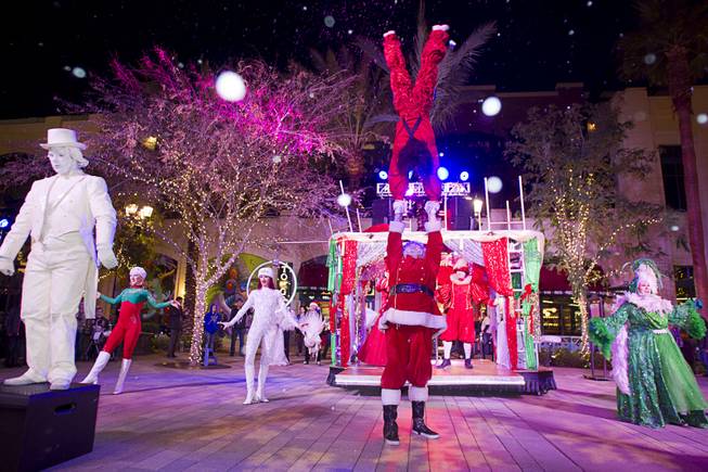 KriStef Brothers Kristofer Saly, top, and Stefan Linden (Santa) perform during the Winter PARQ Show in the Linq Promenade Sunday, Dec. 14, 2014. The free performances  are held daily on the hour from 5 p.m. to 9 p.m. until Dec. 27.