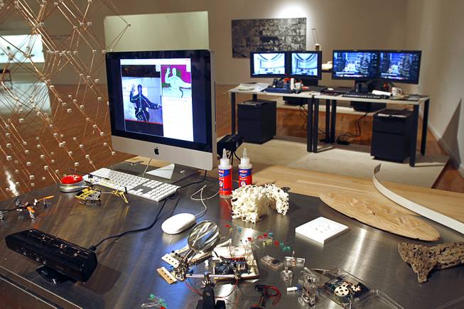 An architect work station of future, foreground, is displayed at Reflecting + Projecting: 20 Years of Design Excellence, an exhibit of architectural design in UNLV's Marjorie Barrick Museum, Monday, Dec. 15, 2014.