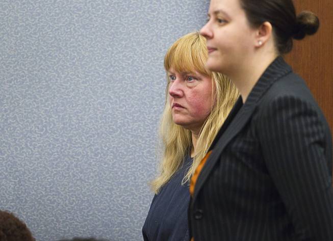 Debra Sena, left, 50, stands by attorney Caitlyn McAmis during a court appearance at the Regional Justice Center in Las Vegas Tuesday, Dec. 16, 2014. Along with husband Christopher Sena, 48, and his ex-wife, Terrie Sena, Debra Sena is accused of participating in sexual abuse that lasted 12 years and affected at least eight victims, some of whom are family members, according to Metro Police.
