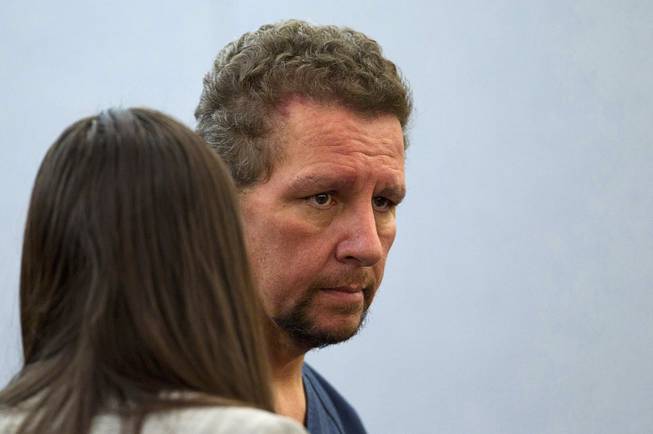 Christopher Sena, 48,  listens to public defender Violet Radosta during a court appearance at the Regional Justice Center in Las Vegas Tuesday, Dec. 16, 2014. Sena is accused of participating in sexual abuse that lasted 12 years and affected at least eight victims, some of whom are family members, according to Metro Police.