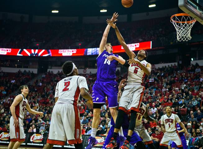 Portland center Riley Barker (14) elevates for a basket over UNLV forward Christian Wood (5) late in the game at the Thomas & Mack Center on Wednesday, December 17, 2014.