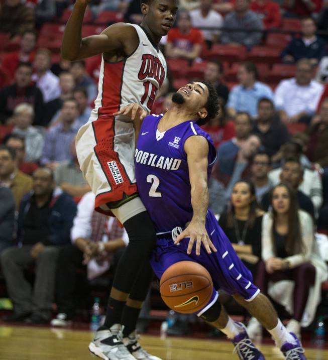 UNLV forward Dwayne Morgan (15) is called for a foul as Portland guard Alec Wintering (2) runs into him during their game at the Thomas & Mack Center on Wednesday, December 17, 2014.