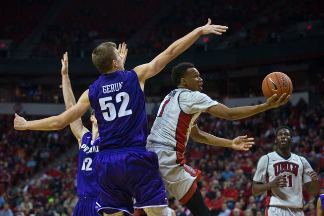UNLV guard Rashad Vaughn (1) floats to the basket for a shot past Portland forward/center Volodymyr Gerun (52) in overtime at the Thomas & Mack Center on Wednesday, December 17, 2014.