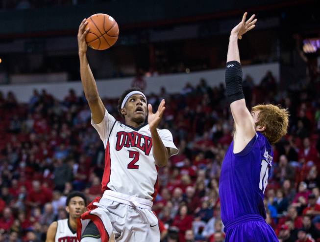 UNLV guard Patrick McCaw (2) gets off a hook shot over the outstretched arm of Portland center Riley Barker (14) late in the game at the Thomas & Mack Center on Wednesday, December 17, 2014.