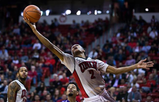 UNLV guard Patrick McCaw (2) stretches out from behind the basket to get off a shot against visiting Portland at the Thomas & Mack Center on Wednesday, December 17, 2014.