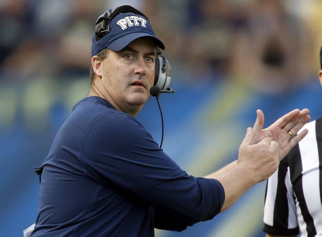 In this Sept. 28, 2013, photo, Pittsburgh head coach Paul Chryst calls a time out in the fourth quarter of an NCAA football game against Virginia in Pittsburgh. 