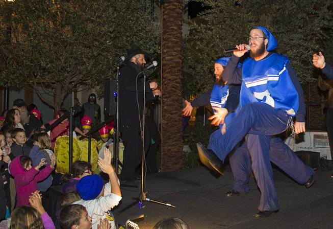 Dancing dreidels perform during a Hanukkah menorah lighting ceremony in The District in Henderson Thursday, Dec. 18, 2014. The event, celebrating the third night of Hanukkah, was organized by Chabad of Green Valley.