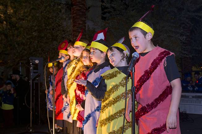 Members of the Chabad Choir, including Levi Harlig, right,  9, during a Hanukkah menorah lighting ceremony in The District in Henderson Thursday, Dec. 18, 2014. The event, celebrating the third night of Hanukkah, was organized by Chabad of Green Valley.