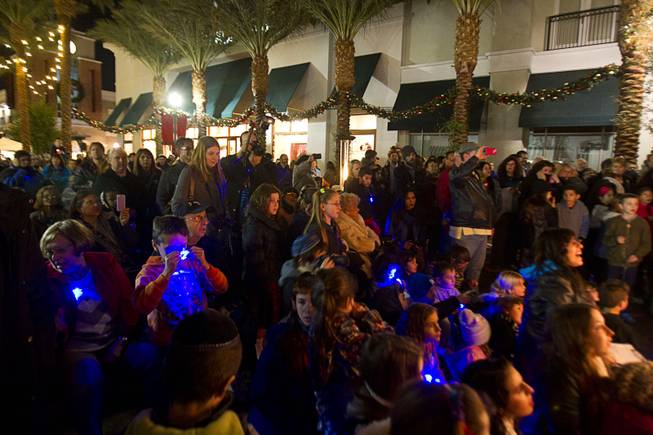 People watch a Hanukkah menorah lighting ceremony in The District in Henderson Thursday, Dec. 18, 2014. The event, celebrating the third night of Hanukkah, was organized by Chabad of Green Valley.