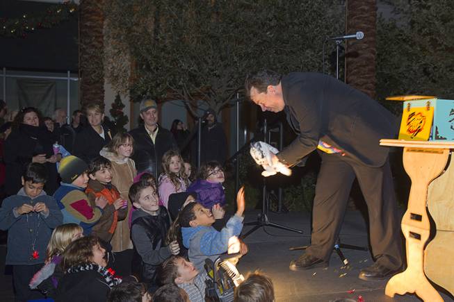 The '"Amazing Arful Roger" performs with Sparkle the bunny during a Hanukkah menorah lighting ceremony in The District in Henderson Thursday, Dec. 18, 2014. The event, celebrating the third night of Hanukkah, was organized by Chabad of Green Valley.