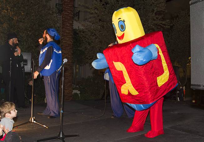 "Penny," a human dreidel, performs during a Hanukkah menorah lighting ceremony in The District in Henderson Thursday, Dec. 18, 2014. The event, celebrating the third night of Hanukkah, was organized by Chabad of Green Valley.