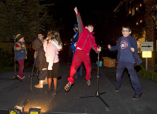 Children sing and dance on stage during a Hanukkah menorah lighting ceremony in The District in Henderson Thursday, Dec. 18, 2014. The event, celebrating the third night of Hanukkah, was organized by Chabad of Green Valley.
