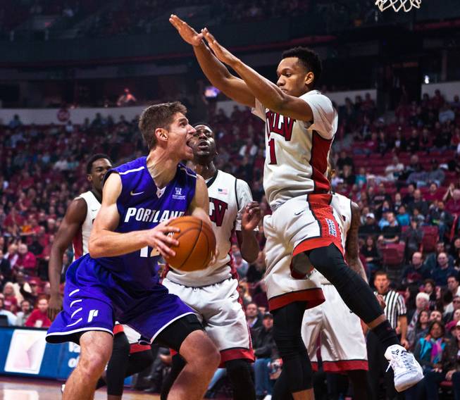 Portland center Thomas van der Mars (12) looks to get off a shot under the basket under tight defense by UNLV guard Rashad Vaughn (1) during their game at the Thomas & Mack Center on Wednesday, December 17, 2014.