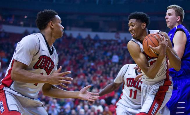 UNLV guard Rashad Vaughn (1) looks to UNLV forward Christian Wood (5) who secures a loose ball during their game at the Thomas & Mack Center on Wednesday, December 17, 2014.