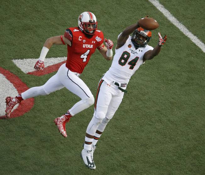 Colorado State wide receiver Xavier Williams (84) misses a catch while guarded by Utah defensive back Brian Blechen (4) during the second half of the Las Vegas Bowl NCAA college football game Saturday, Dec. 20, 2014, in Las Vegas. Utah won 45-10. (AP Photo/John Locher)