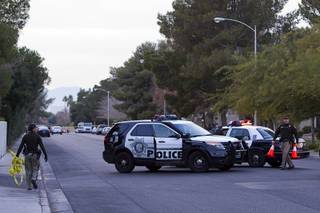 Metro Police block off Tompkins Avenue after an officer-involved shooting near East Tompkins Avenue and Mohave Road Sunday, Dec. 21, 2014.