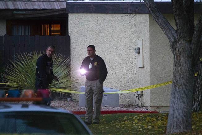 Metro Police and crime scene analysts investigate an officer-involved shooting near East Tompkins Avenue and Mohave Road Sunday, Dec. 21, 2014.