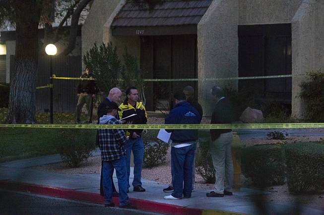 Metro Police and crime scene analysts investigate an officer-involved shooting near East Tompkins Avenue and Mohave Road Sunday, Dec. 21, 2014.