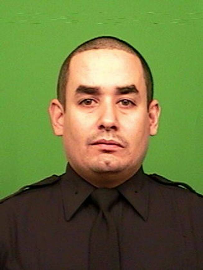 This photo provided by the New York Police Department shows officer Rafael Ramos. Ramos and officer Wenjian Liu were shot and killed Saturday, Dec. 20, 2014, in the Brooklyn borough of New York. The suspect, 28-year-old Ismaaiyl Brinsley, ran to a subway station and killed himself.