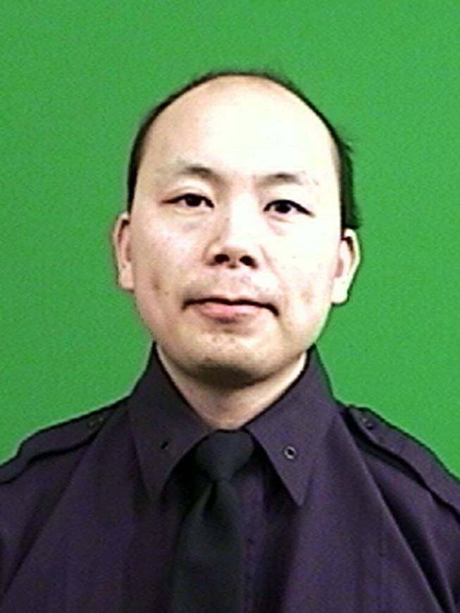This photo provided by the New York Police Department shows officer Wenjian Liu. Liu and officer Rafael Ramos were shot and killed Saturday, Dec. 20, 2014, in the Brooklyn borough of New York. The suspect, 28-year-old Ismaaiyl Brinsley, ran to a subway station and killed himself.