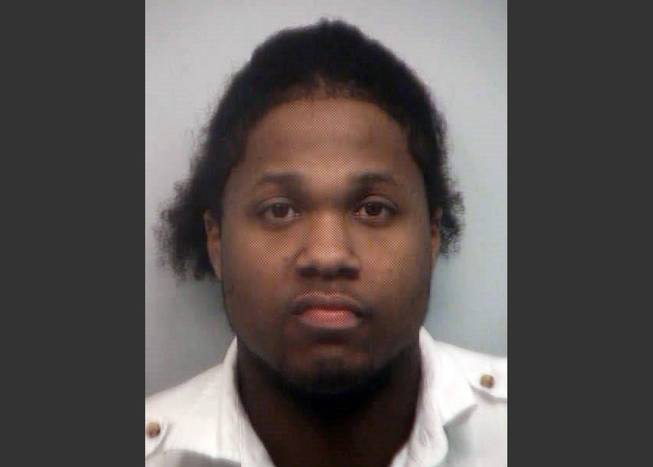 This 2010 booking photo provided by the Fulton County, Ga., Sheriff's Office shows Ismaaiyl Brinsley after he was arrested on charges of terroristic threats, simple battery and marijuana possession. Brinsley ambushed two New York City police officers in their patrol car in broad daylight Saturday, Dec. 20, 2014, fatally shooting them before killing himself inside a subway station.