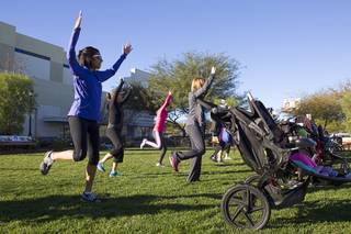 Delilah Licon, left, and other moms warm up during Stroller Strides, a Fit4Mom exercise class at Town Square, Monday, Dec. 22, 2014.