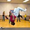 Airman 1st Class Jerryl Franklin completes a flip during a dance contest he went on to win at Nellis Air Force Base during the USO's Christmas Day feast for active-duty military personnel Thursday, Dec. 25, 2014.